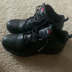 Black Steel Toed Men Reebok shoes.